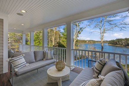 Sandwich Cape Cod vacation rental - An inviting outdoor seating area overlooking the serene pond