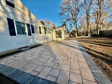 Hyannis Cape Cod vacation rental - Back yard, with grill, couch, dining table and ping pong table