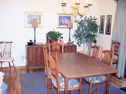 Dennis Cape Cod vacation rental - Ding room with sliders to large deck with table and propane grill