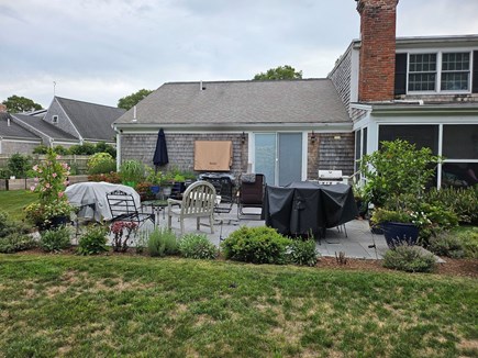 Chatham Cape Cod vacation rental - Patio with seating and dining area, outdoor tv, Blackstone, gas and charcoal grill, and herb garden