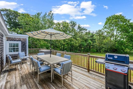 Harwich Cape Cod vacation rental - Deck with grill, outdoor dining, and seating area
