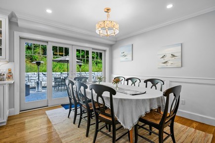 Harwich Port Cape Cod vacation rental - Dining table overlooking back yard entertainment area.