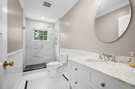 Harwich Port Cape Cod vacation rental - Full bathroom (#1) with shower in main level hallway.