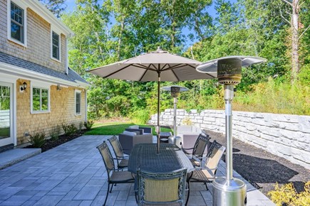 Harwich Port Cape Cod vacation rental - Backyard oasis with lounging and dining areas.
