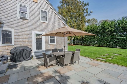 Harwich Port Cape Cod vacation rental - Patio off of the Main House with outdoor dining area and grill