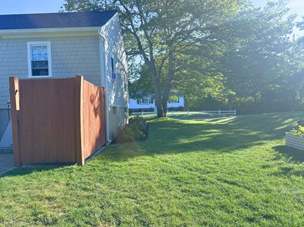 Dennis Village Cape Cod vacation rental - Back/side yard with outdoor shower, accessible from walk-out deck