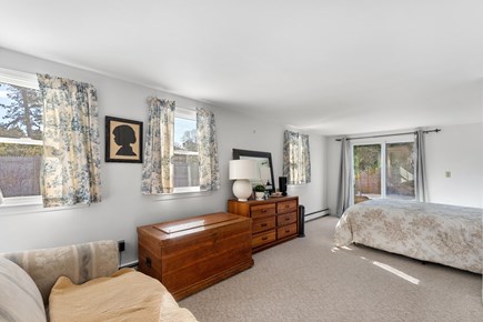 Eastham, Sand Dollar Cape Cod vacation rental - Spacious queen bedroom with dresser & sliding door to the yard
