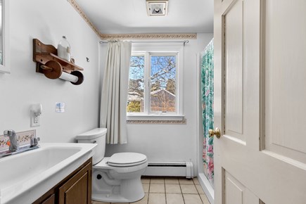 Eastham, Sand Dollar Cape Cod vacation rental - Full bathroom with a tub, shower, and coastal turquoise tile