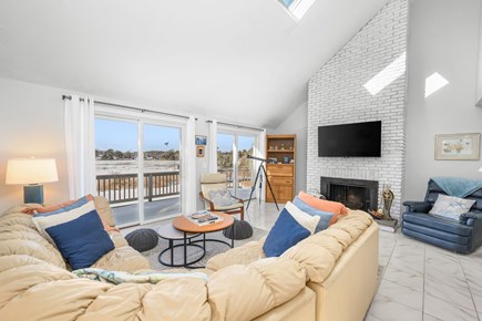 West Dennis Cape Cod vacation rental - Living room with cozy seating and sliding glass doors that lead out to the deck