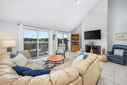 West Dennis Cape Cod vacation rental - Living room with cozy seating and sliding glass doors that lead out to the deck