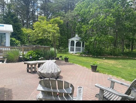 Yarmouth Cape Cod vacation rental - Private yard with lush plants and flowers, firepit, patio & decks