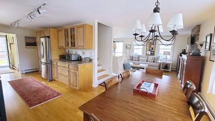 Wellfleet Cape Cod vacation rental - Dining area with kitchen and living room beyond