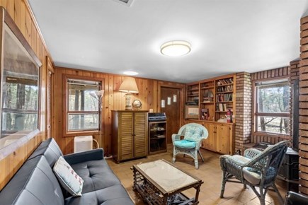 Wellfleet, Marshside Escape Cape Cod vacation rental - Wood paneled den with lounge seating and built in shelves
