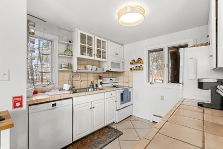Wellfleet, Marshside Escape Cape Cod vacation rental - Well stocked kitchen with natural light and water glimpses