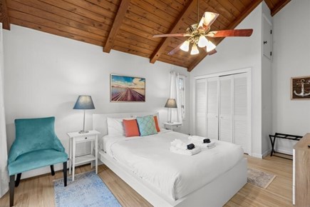 Wellfleet, Marshside Escape Cape Cod vacation rental - Main level bedroom with queen bed and vaulted wood ceiling