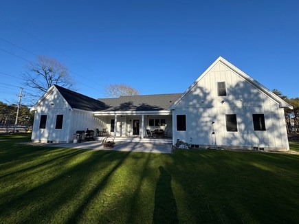 Harwich Cape Cod vacation rental - Back yard. 8 person dining table, grill, and smoker