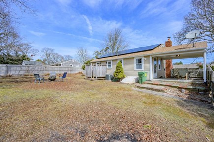 South Yarmouth Cape Cod vacation rental - Backyard featuring an outdoor shower and fire pit