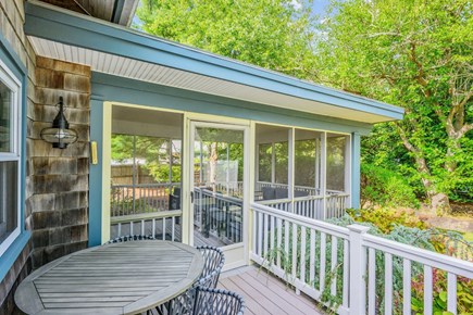 South Yarmouth Cape Cod vacation rental - Deck off of screened porch view with additional table and seating
