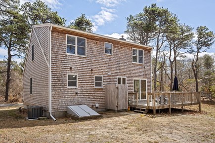 Eastham Cape Cod vacation rental - Backyard with wrap-around deck and outdoor hot/cold shower