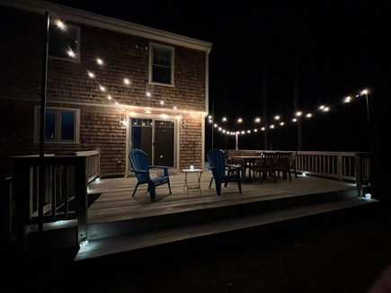 Eastham Cape Cod vacation rental - Deck with string lights and outdoor dining