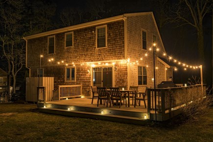 Eastham Cape Cod vacation rental - Back yard at night with string lights on