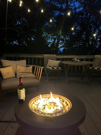 Wellfleet Cape Cod vacation rental - Back porch with sectional seating by the firepit and solar lights