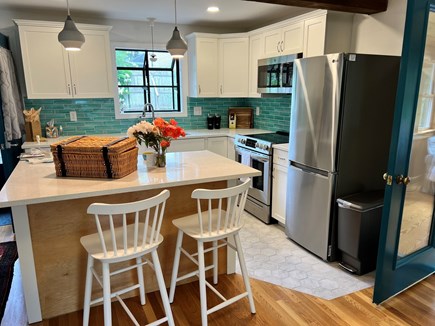 Wellfleet Cape Cod vacation rental - Kitchen with counter seating opens to dining and living area