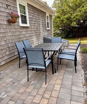 South Yarmouth Cape Cod vacation rental - Backyard patio with grill and outdoor table/chairs
