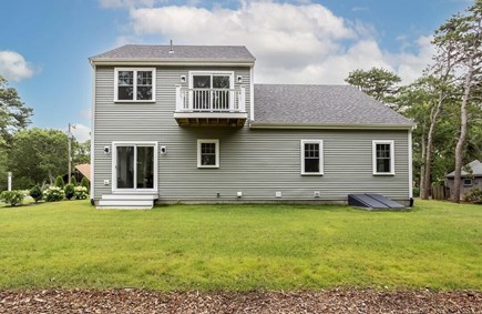 South Yarmouth Cape Cod vacation rental - Backyard with lake view, stone patio currently being installed