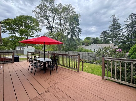 Eastham Cape Cod vacation rental - Spacious deck, shaded seating area, and grill for outdoor dining
