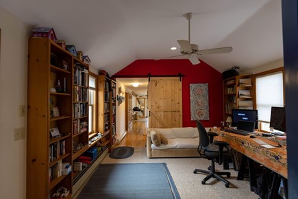 Eastham Cape Cod vacation rental - Entrance from large garage. Library. Barn door closes off room.
