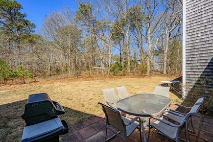 Dennis Cape Cod vacation rental - Back patio with grill and dining table