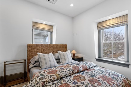 Provincetown, The Tucker House Cape Cod vacation rental - Upstairs bedroom with soft light, cozy textiles, unwind
