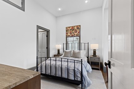 Provincetown, The Tucker House Cape Cod vacation rental - Serene bedroom with high ceilings and soft natural light.