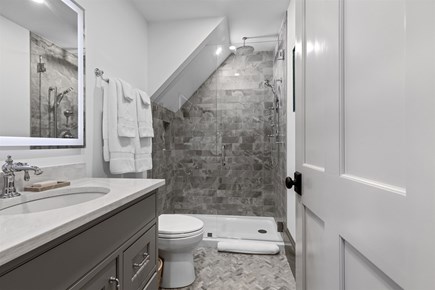 Provincetown, The Tucker House Cape Cod vacation rental - Bathroom with glass shower and elegant stone tile