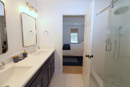 Brewster Cape Cod vacation rental - Primary en suite with custom tile shower & double sinks<br/>