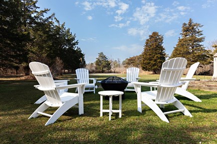 Eastham Cape Cod vacation rental - Spacious backyard with Adirondack chairs and a firepit