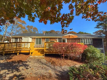 Harwich Port Cape Cod vacation rental - Full back deck, outdoor shower — classic Cape Cod kit.