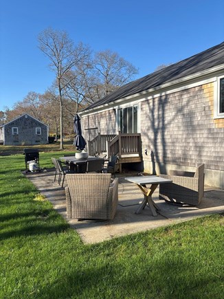 Yarmouthport Cape Cod vacation rental - Backyard chairs and dining table for outside relaxation