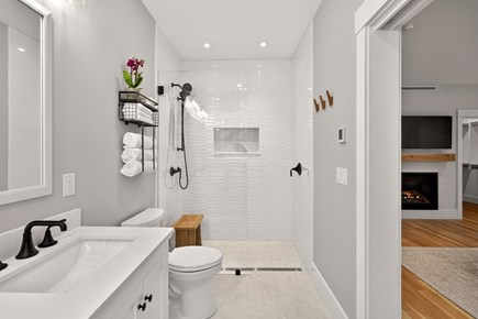 Harwich Cape Cod vacation rental - First floor primary bath with curbless shower, double sink