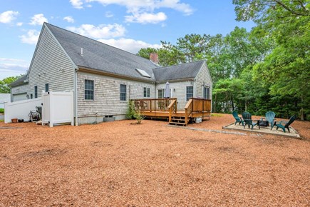 Dennis Cape Cod vacation rental - Backyard with fire deck, fire pit area and outdoor shower