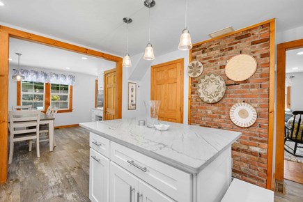 Osterville Cape Cod vacation rental - Kitchen flows seamlessly into the dining area, creating an open and connected space for meals and gathering.