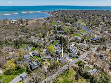 Osterville Cape Cod vacation rental - Aerial view highlighting the property, stone driveway, and surrounding neighborhood setting.