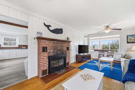 Bourne, Buzzards Bay Cape Cod vacation rental - Living room featuring a ceiling fan and large windows that fill the space with natural light