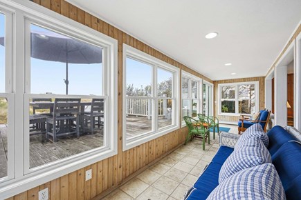Bourne, Buzzards Bay Cape Cod vacation rental - Sunroom with views of the deck and nearby back steps, creating a bright and relaxing space
