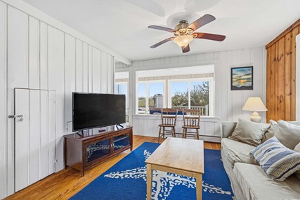 Bourne, Buzzards Bay Cape Cod vacation rental - Living room featuring a ceiling fan and large windows that fill the space with natural light