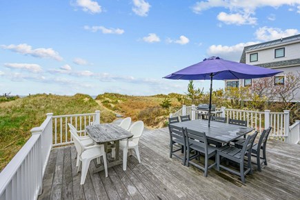 Bourne, Buzzards Bay Cape Cod vacation rental - Deck featuring two tables, providing ample outdoor seating for dining, entertaining, and relaxing in a comfortable open-air setting.