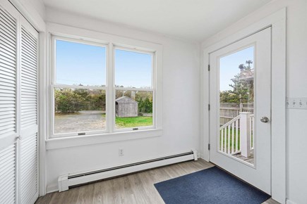 Bourne, Buzzards Bay Cape Cod vacation rental - Entryway with a large window beside the door, creating a bright and welcoming first impression with natural light flowing into the space