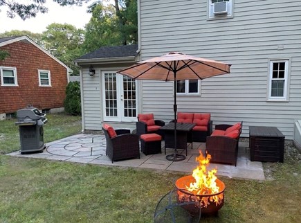 East Falmouth Cape Cod vacation rental - Back patio area with furniture and propane grill for use.