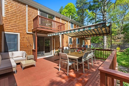 Centerville Cape Cod vacation rental - The perfect deck with dining, sunsetter awning and lounge set.